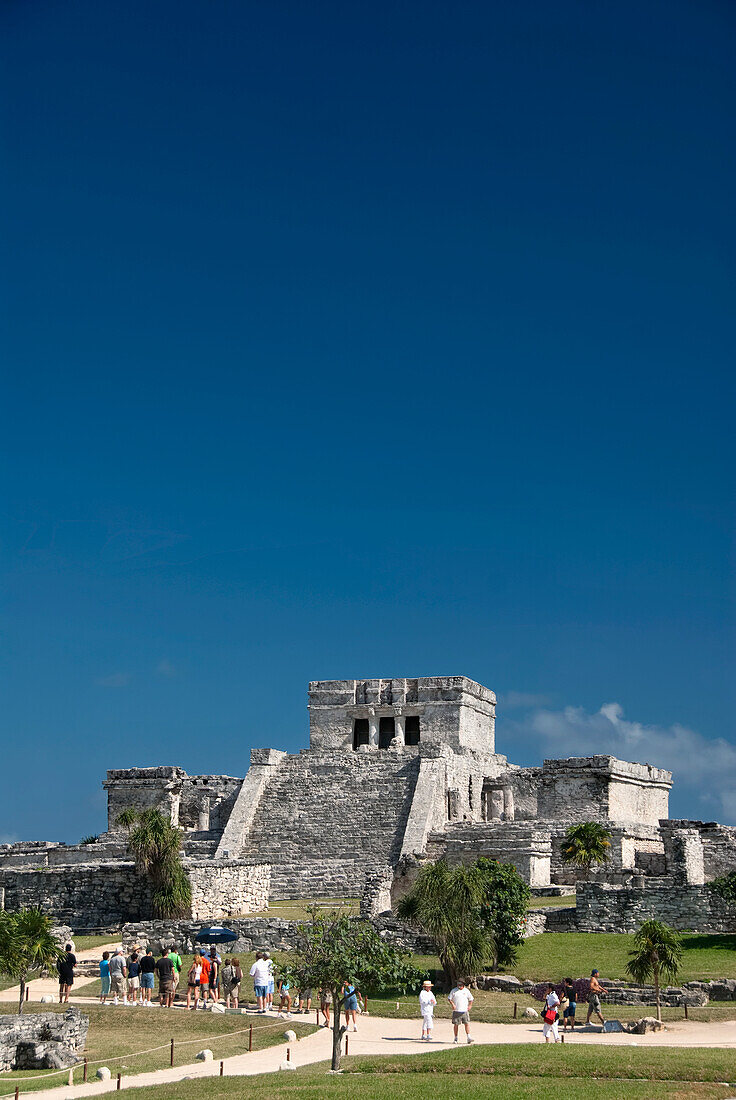 Mexico, Quintana Roo, Tulum, the Mayan ruins of Tulum, El Castillo (the Castle), tourists enjoying the view