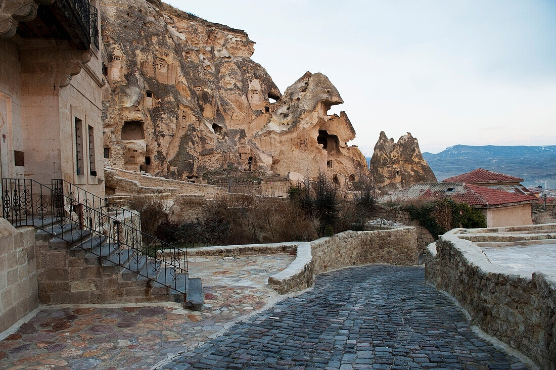 Steps Coming Out Of The Side Of A Building With A Stone Street Lined By Short Stone Walls; Nevsehir Turkey