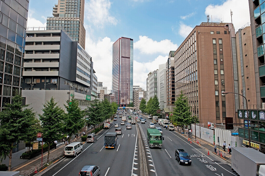 Japan, Tokyo, Traffic on road in busy urban area