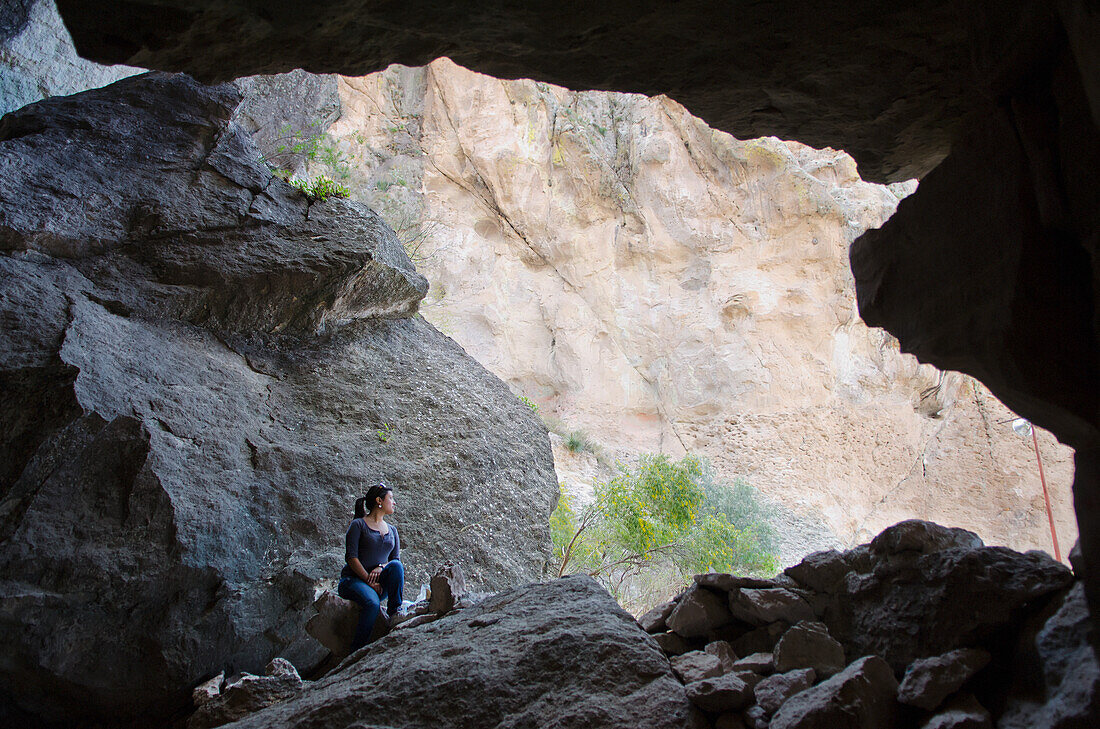 Young woman sitting in caves of La Bufa; Guanajuato, Guanajuato State, Mexico