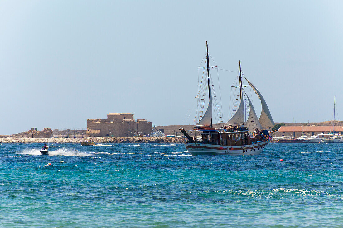 Large ship sailing in harbor and a rider on a personal watercraft; Paphos, Cyprus