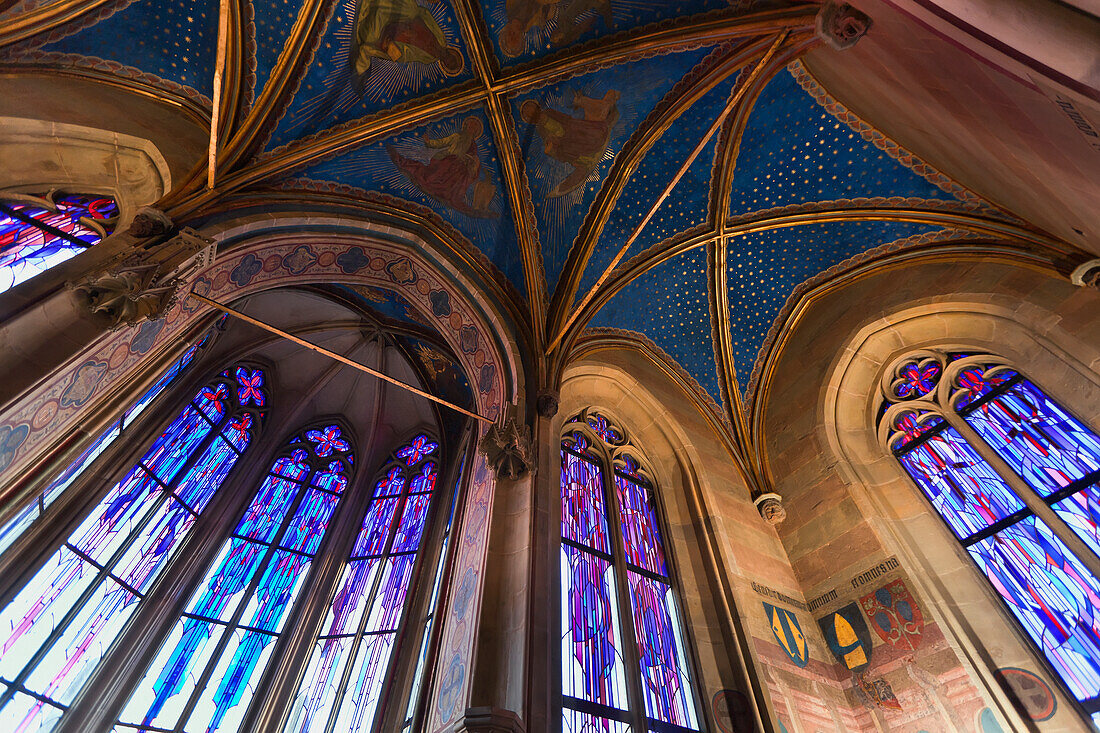 Czech Republic, Low angle view of stained glass windows and painted dome ceiling of church; Prague
