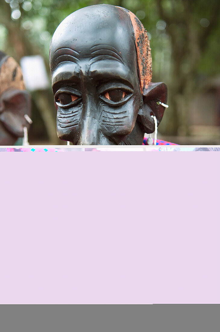 Wooden carving of tribesman in colorful fabric; Nairobi, Kenya