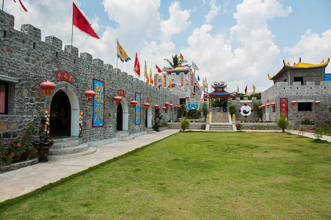 Thailand, Flags and lanterns line outside of building in Chinese village; Shandicun