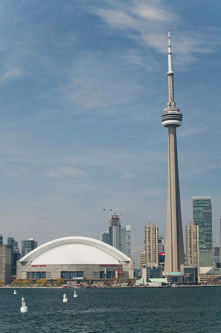 The Skydome And Cn Tower From Lake Ontario With Blue Sky And Clouds; Toronto, Ontario, Canada