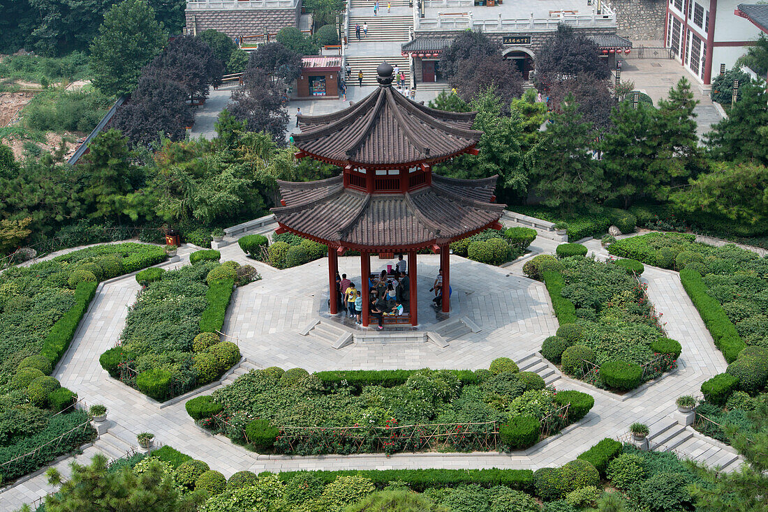 High Angle View Of People Sitting Under A Pagoda; Xi'an, Shaanxi, China