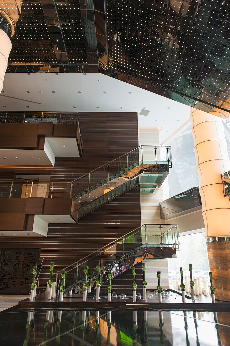 Interior Of A Building With Glass Railings On A Staircase And Shiny Tiled Floors; Beijing, China