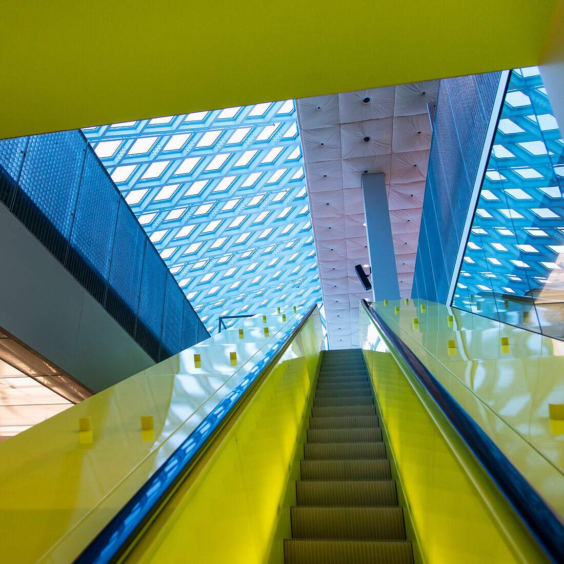 Escalator With Bright Yellow Sides And A Patterned Ceiling In Seattle Central Library; Seattle, Washington, United States Of America