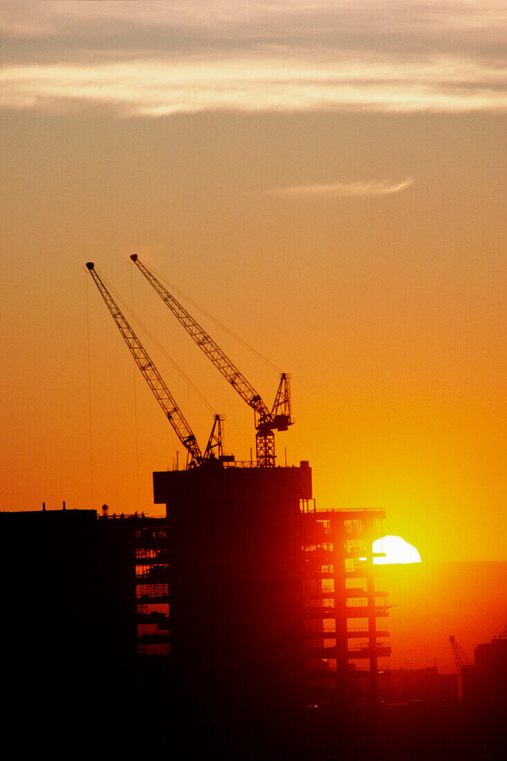 Bürogebäude Baukräne, Sonnenuntergang Silhouette