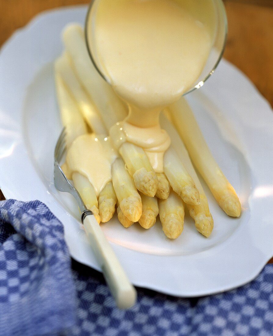 Hollandaise Sauce Pouring Over White Asparagus