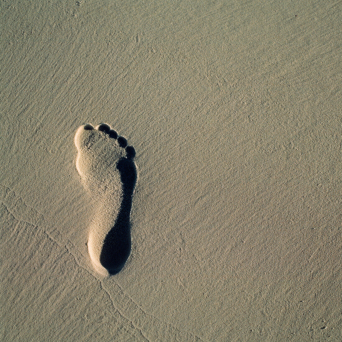 Fußabdruck im Strandsand