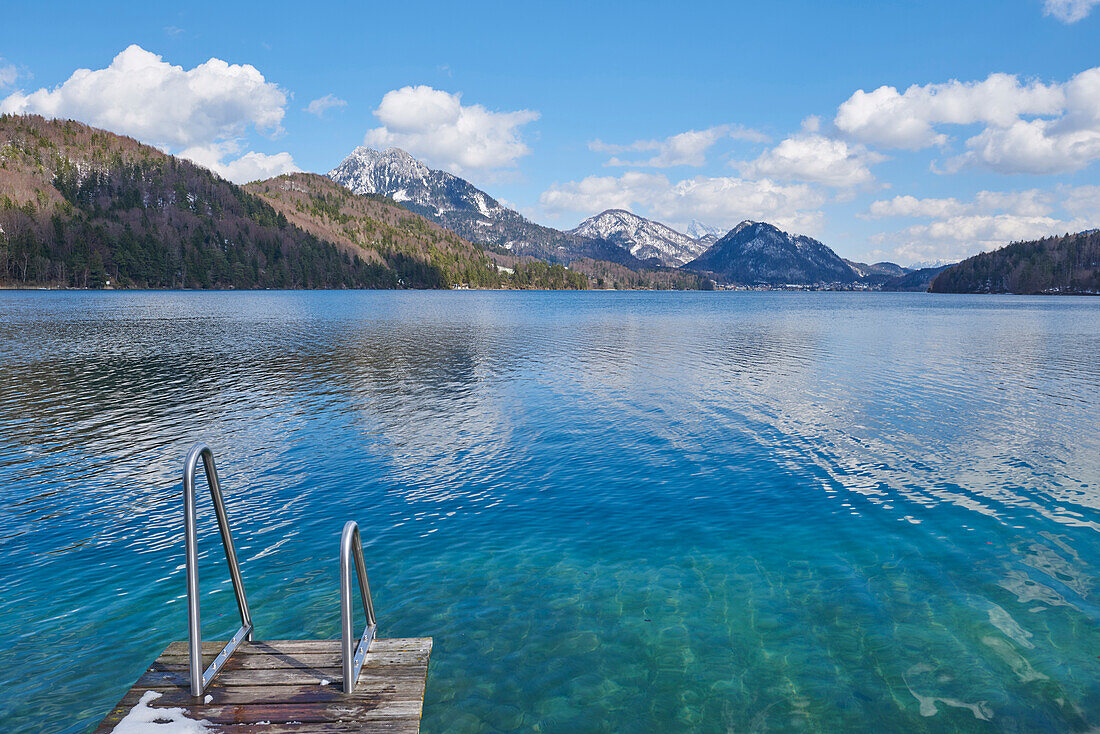 Dock on Fuschlsee with Mountains in the background in Early Spring, Austria