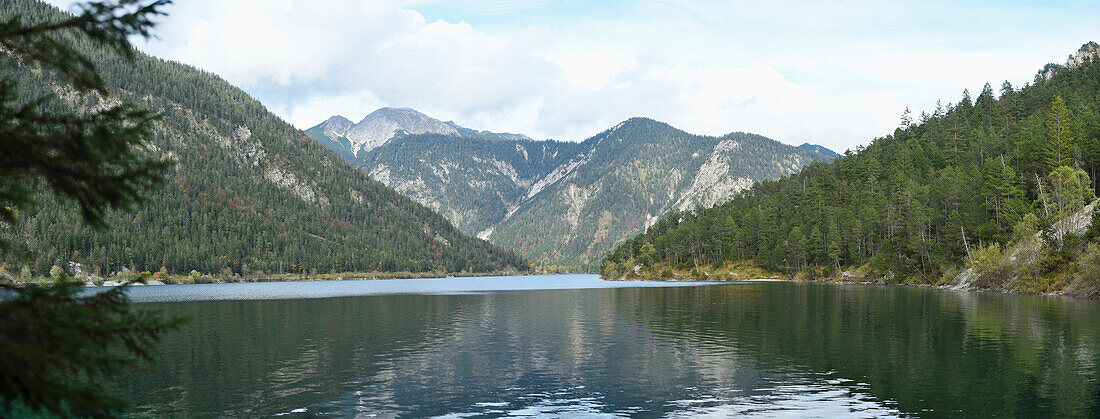 Scenic view of mountains and a clear lake (Plansee) in autumn, Tirol, Austria