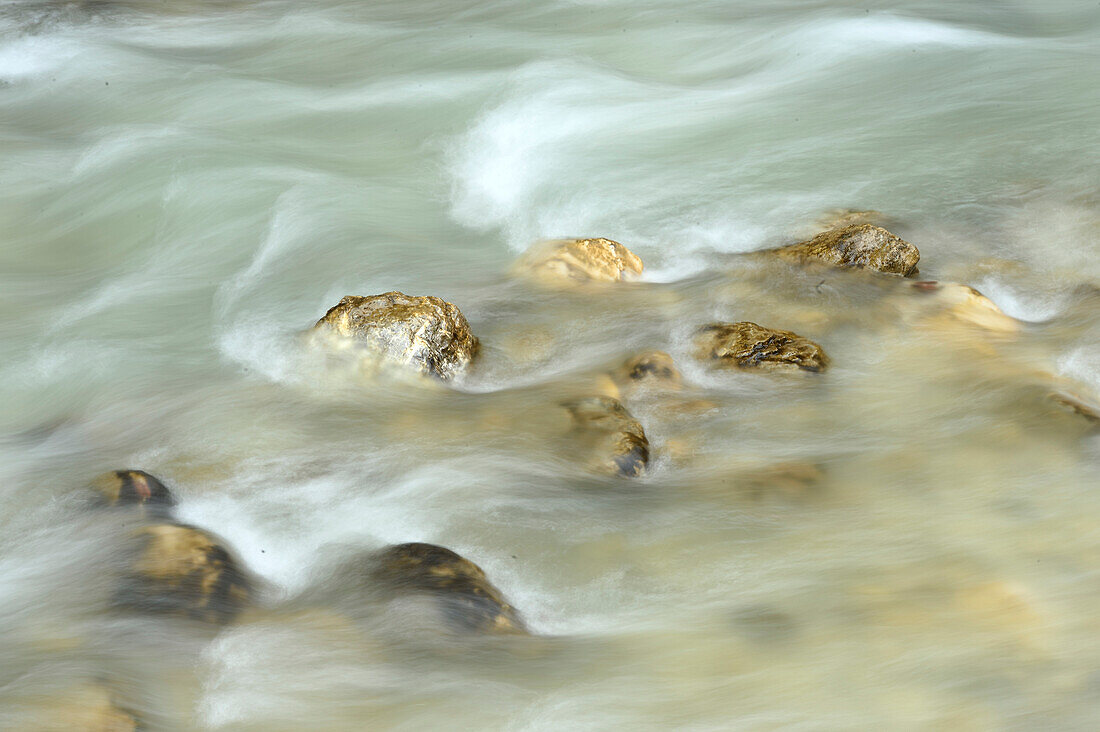 Close-up of flowing water and rocks in Partnach Gorge in autumn, Upper Bavaria, Germany