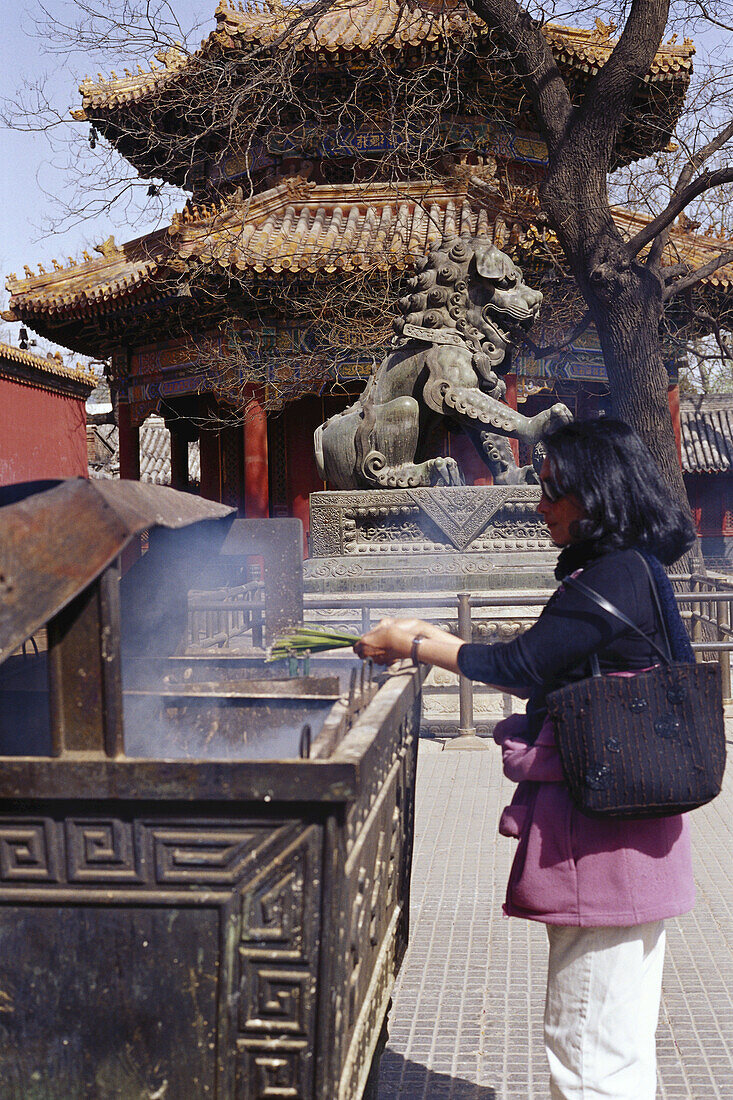 Woman Lighting Incense at The Lamma Temple, Beijing, China