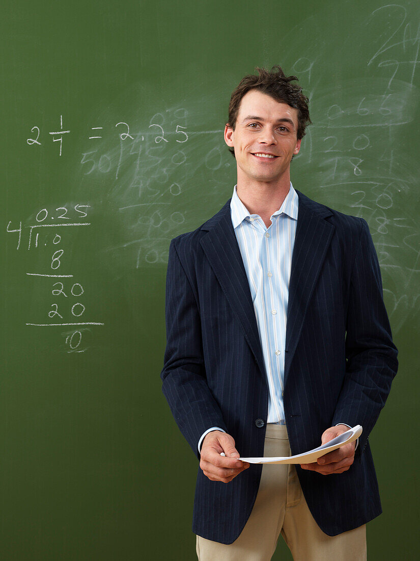 Teacher Standing in Front of Blackboard