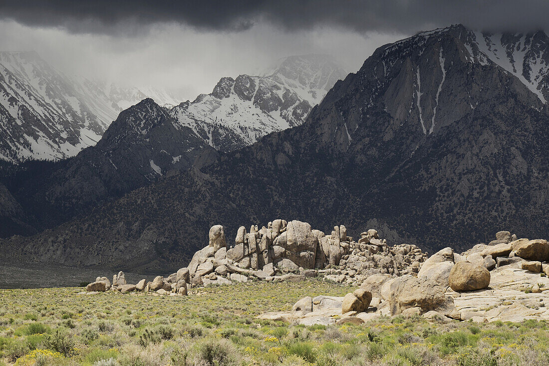Alabama Hills and storm clouds over the mountains of the Sierra Nevadas in Eastern California, USA