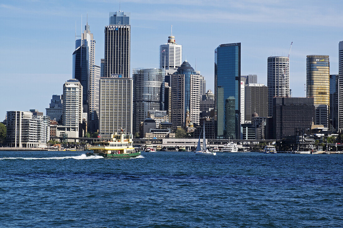 Ferry boat approaching teminal at  Circular Quay and skyline of Sydney, Australia