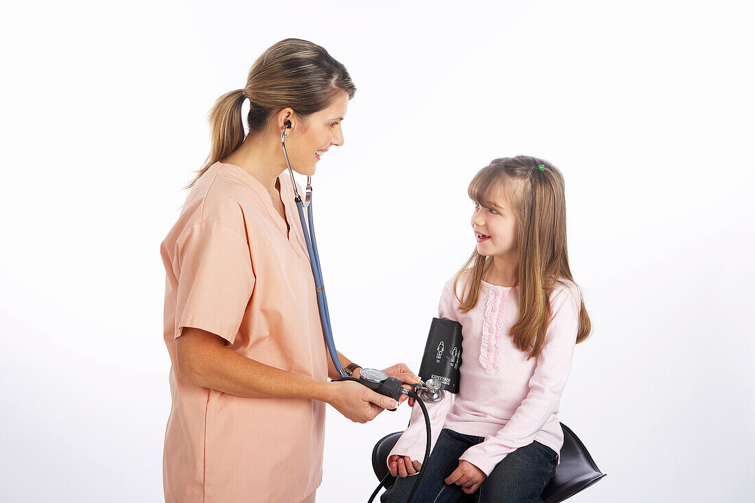 Nurse Checking Girl's Blood Pressure