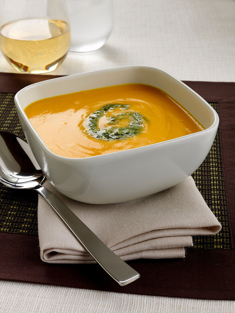 Bowl of Carrot Soup with Glass of White Wine