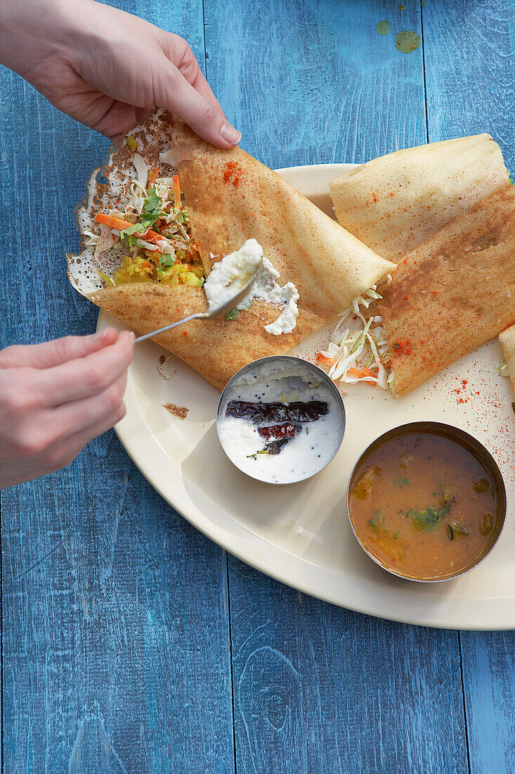 Dosa Filled With Curried Potato, Coconut Chutney, and Sambhar