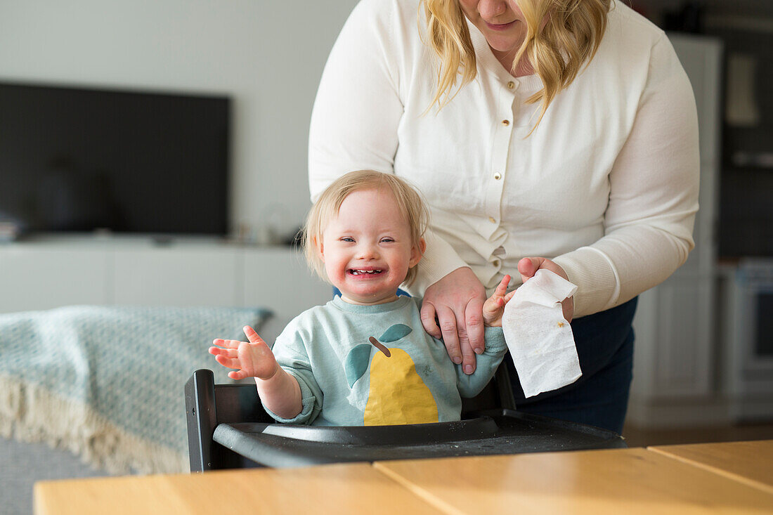 Toddler with down syndrome at table