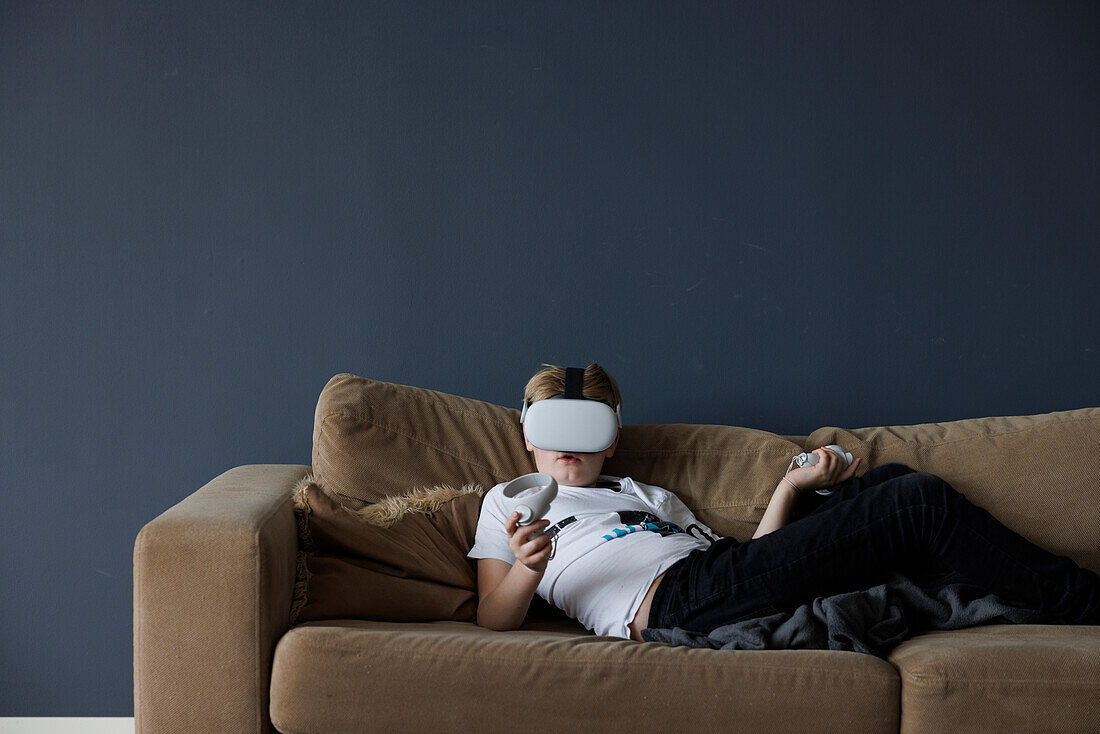 Boy wearing virtual reality goggles during VR experience