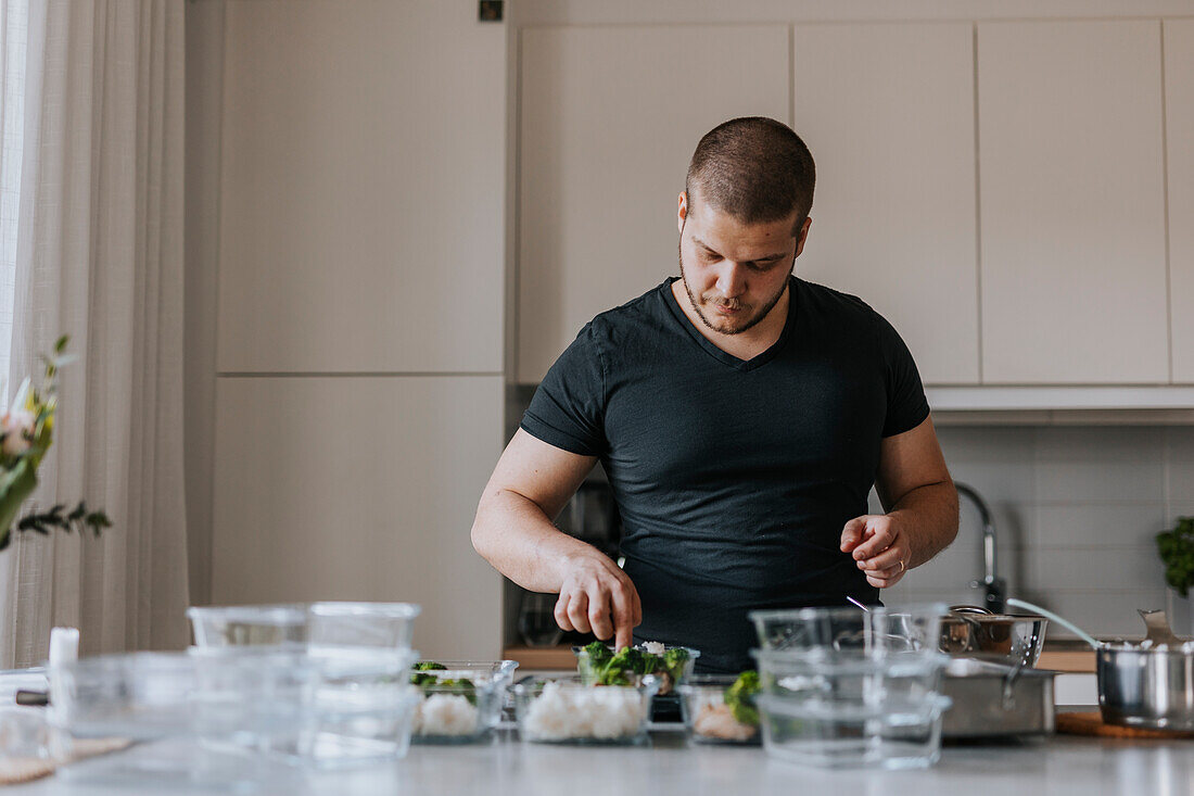 Man doing healthy meal prep at home
