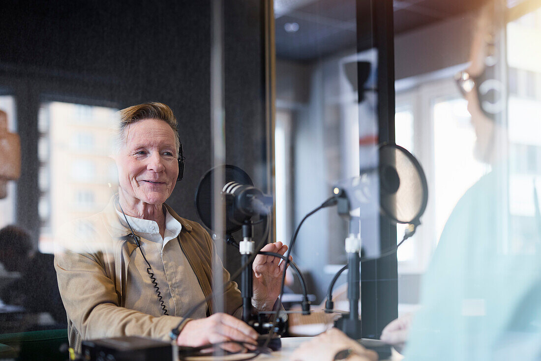Male radio presenter talking with his guest on radio show or podcast