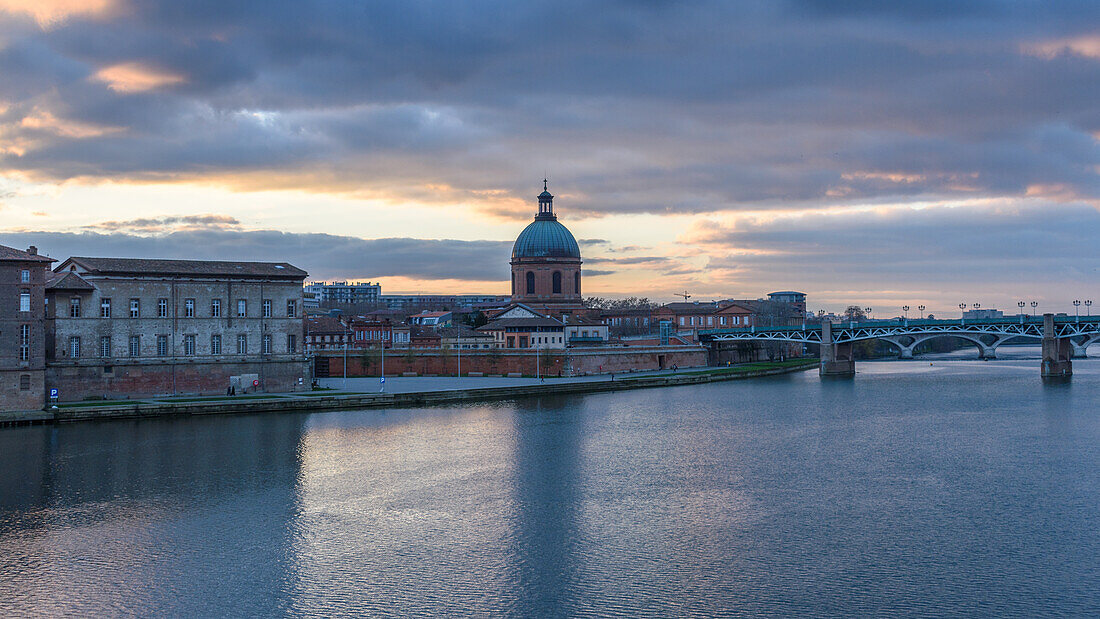 View across the Garonne river to The Hôpital de La Grave hospital, with a dome and bell tower. 