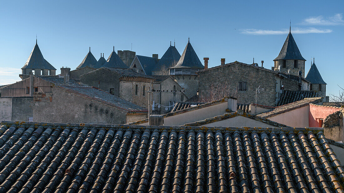 Die Skyline der Zitadelle, Château Comtal und mittelalterliche Gebäude mit Spitzdächern in der Cité von Carcassonne, hohe Türme und Mauer.