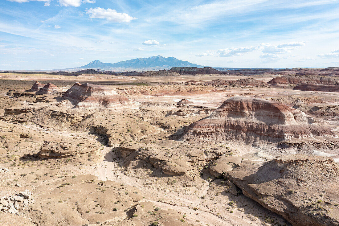 Aerial view of the colorful Bentonite Hills with the Henry Mountains behind, near Hanksville, Utah.