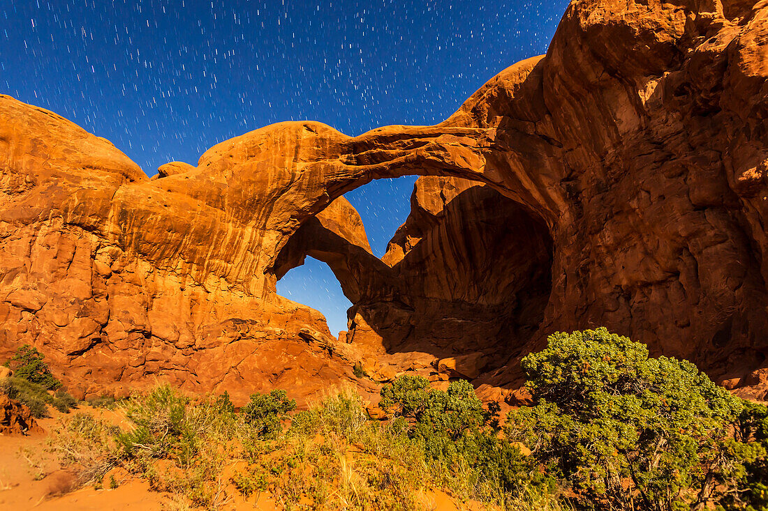 The famous and photogenic Double Arch at Arches National Park in Utah, shot in moonlight with illumination from a rising waning gibbous Moon on April 6, 2015.