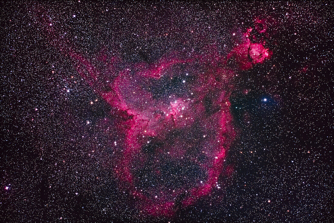 The large emission nebula IC 1805 in Cassiopeia, aka the Heart Nebula. The round nebula at top right is NGC 896. The large loose star cluster at centre is Mel 15; the star cluster at left is NGC 1027. The small cluster below NGC 896 is Tombaugh 4.