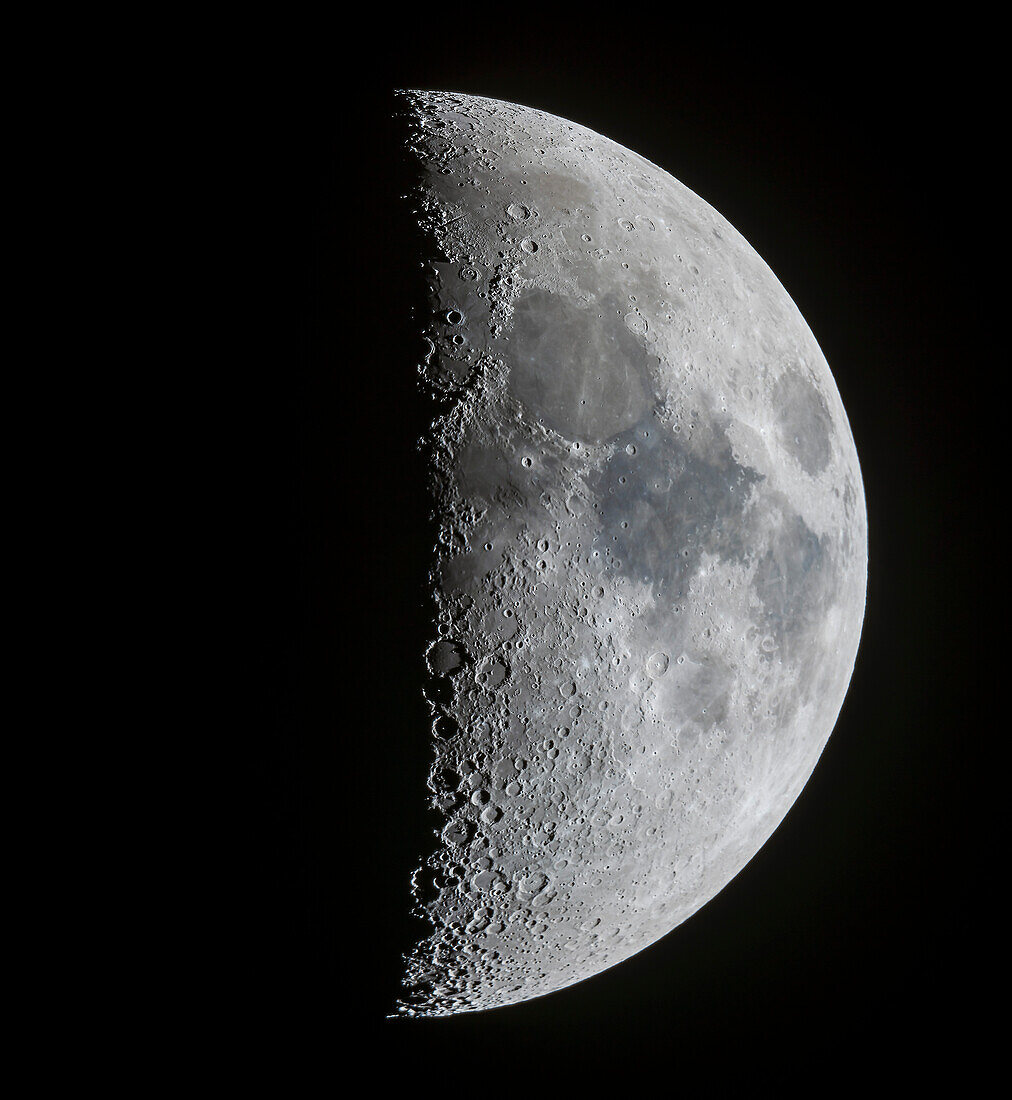 A panorama of the 7-day-old first quarter Moon on March 13, 2019, showing the full disk and extent of incredible detail along the terminator, the dividing line between the day and night sides of the Moon where the Sun is rising as seen from the surface of the Moon. Note the tiny points of light at the centres of some of the craters (particularly Alphonsus and Arzachel below centre) in the Southern Highlands from sunlight just catching the central peaks of those craters. At top in the north the slash of the Alpine Valley is obvious as well as the curve of the Apennine Mountains.
