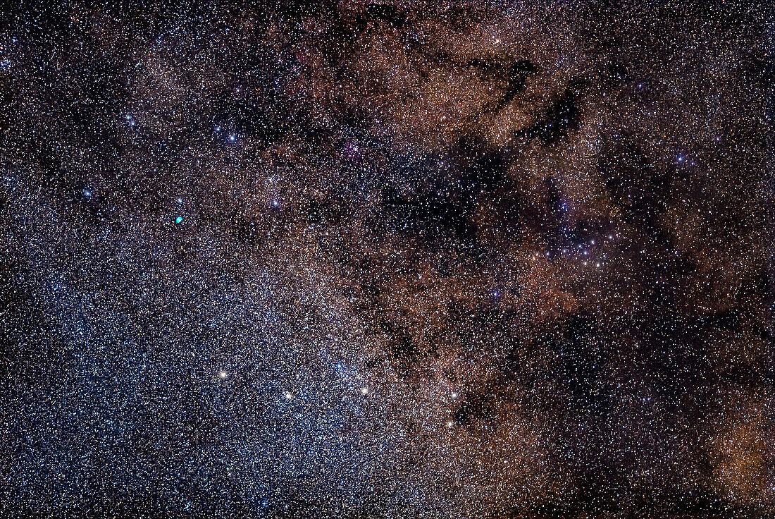 A telephoto closeup of a region of the Milky Way containing an odd assortment of targets: the small constellation of Sagitta the Arrow (at bottom) with the small cluster M71, the green Dumbbell Nebula, M27, in Vulpecula the Fox (at upper left), and the asterism known as the Coathanger (at right), also known as Brocchi’s Cluster.