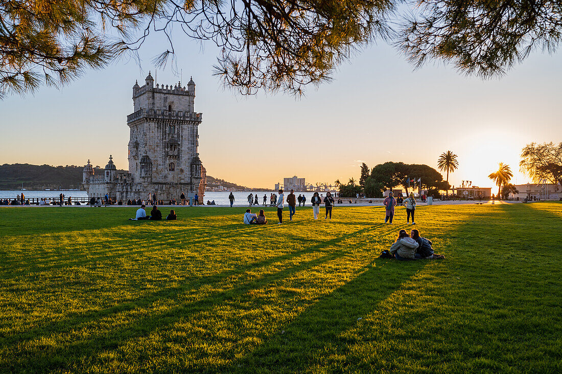 People enjoying Belen Tower Garden (Jardim da Torre de Belem) at sunset, Lisbon, Portugal