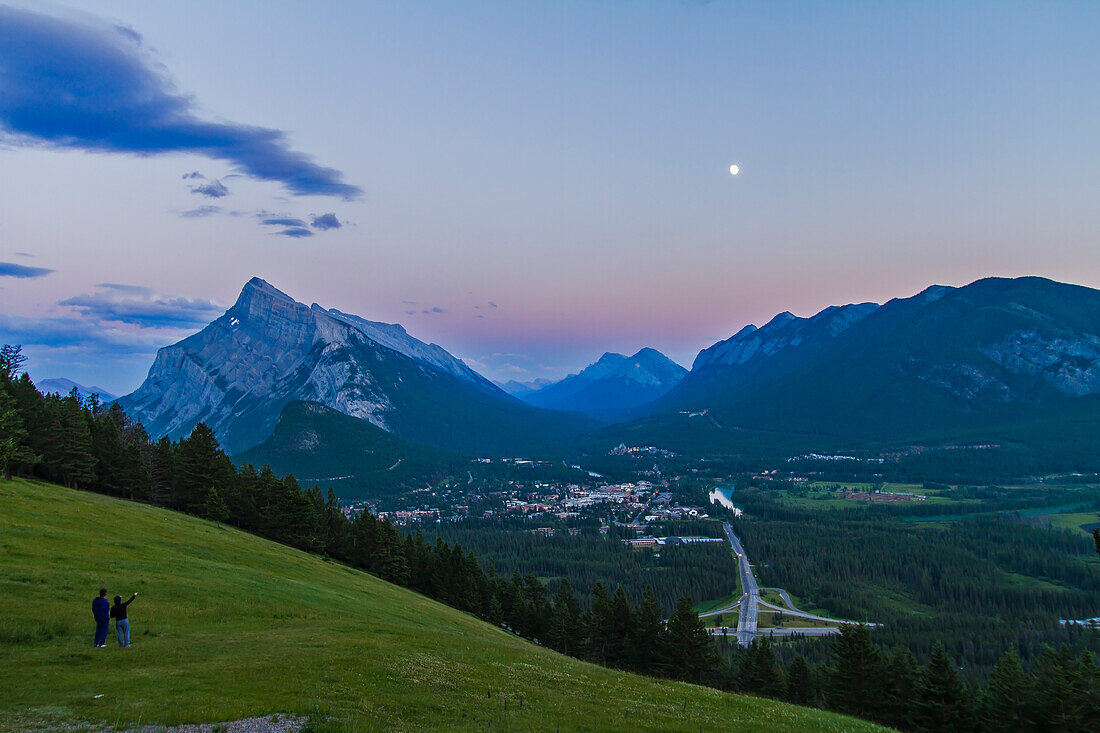 Gibbous Moon over Banff townsite, Banff National Park, Alberta, Canada. Taken July 29, 2012 with Canon 7D and 10-22mm lens at ISO 100, f/6.3 and metered. Taken in twilight. Peak is left is Mt. Rundle. Taken from Mt. Norquay viewpoint overlooking town looking south.