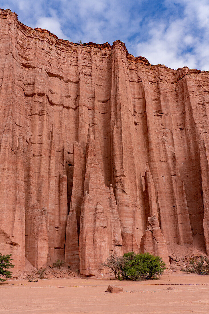 The spires of the Gothic Cathedral in the eroded red sandstone wall in Talampaya National Park, La Rioja Province, Argentina.