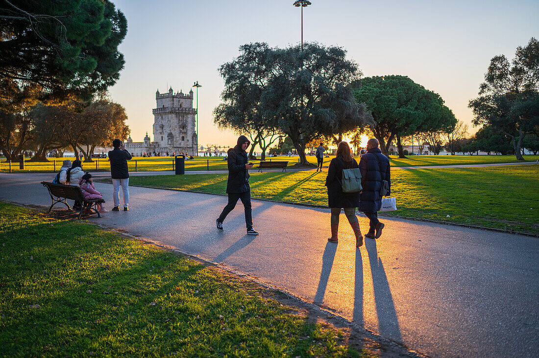 People enjoying Belen Tower Garden (Jardim da Torre de Belem) at sunset, Lisbon, Portugal