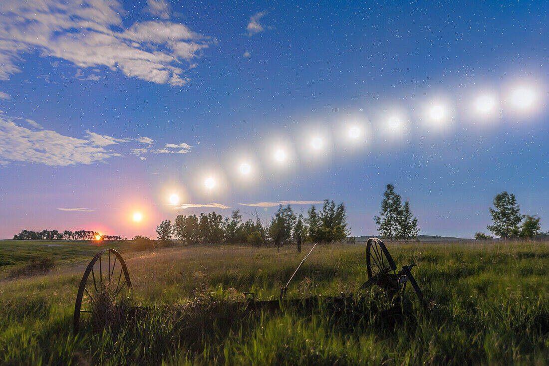 A composite stack of 12 images taken June 11/12, 2017 of the waning gibbous Moon tracking low across the southern sky on a June nght, from moonrise at left at 11:30 pm to when it began to leave the frame at right at 4 a.m. and when the sky was brightening with dawn. Images are at 25-minute intervals. The sky is blue here from the moonlight.