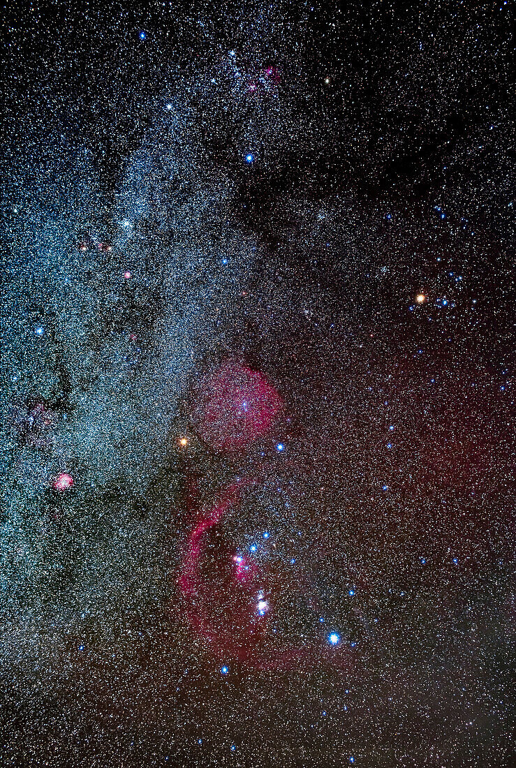 Orion and Taurus (at top) beside the Milky Way, with Betelgeuse dimmer than usual at this time (about magnitude +1.3) during one of its fading episodes. The Taurus Dark Clouds are at top. Barnard’s Loop, apparently now thought to be a supernova remnant and not a bubble, is at lower left encircling Orion. The Rosette Nebula is at far left. The Auriga clusters and nebulas are at top, as is M35 in Gemini.
