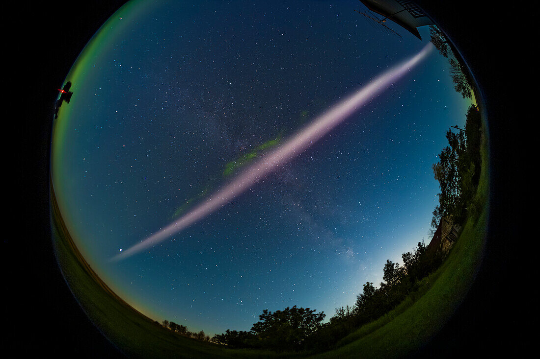A portrait of the infamous STEVE arc of hot flowing gas associated with an active aurora, here showing his distinctive pink colour and the fleeting appearance of the green picket fence fingers that often show up hanging down from the main arc. On this night the green fingers lasted no more than two minutes. STEVE = Strong Thermal Emission Velocity Enhancement, and is a river of hot gas flowing east to west equatorward of the main aurora band. STEVE appeared after the main Kp5-level aurora died down in activity to the north, typical behaviour for STEVE. He was visible for only 35 to 40 minutes,