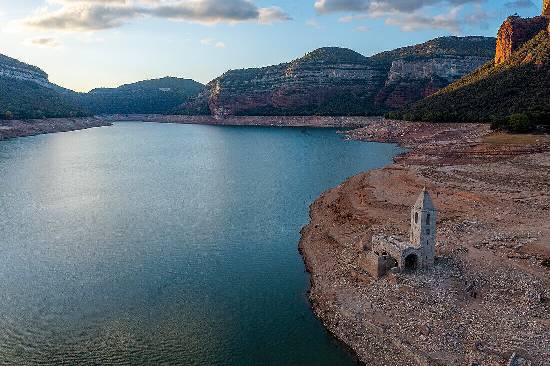 Sau reservoir and Sant Romà de Sau church during a drought, Osona, Barcelona, Spain