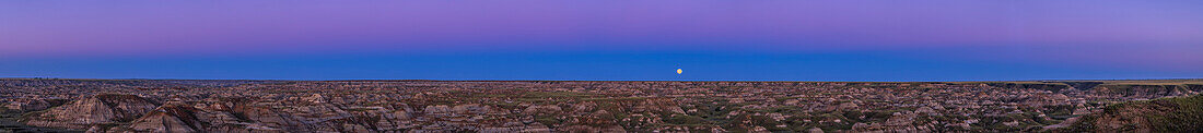 The rising "supermoon" of July 12, 2022 embedded in the blue arc of Earth's shadow, rimmed by the pink Belt of Venus band of twilight colours, all over the badlands formations of Dinosaur Provincial Park on the Red Deer River in Alberta, Canada. The blue arc is the shadow of the Earth cast onto the atmosphere opposite the sunset point. The pink Belt of Venus is from red sunlight still illuminating the upper atmosphere, an effect that lasts only a few minutes at sunset or sunrise, and requires a very clear sky to show up, as it was this night.