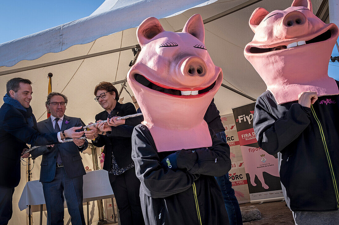 Authorities and mascots during the opening. Firaporc, pig fair, Riudellots de la Selva, Catalonia, Spain