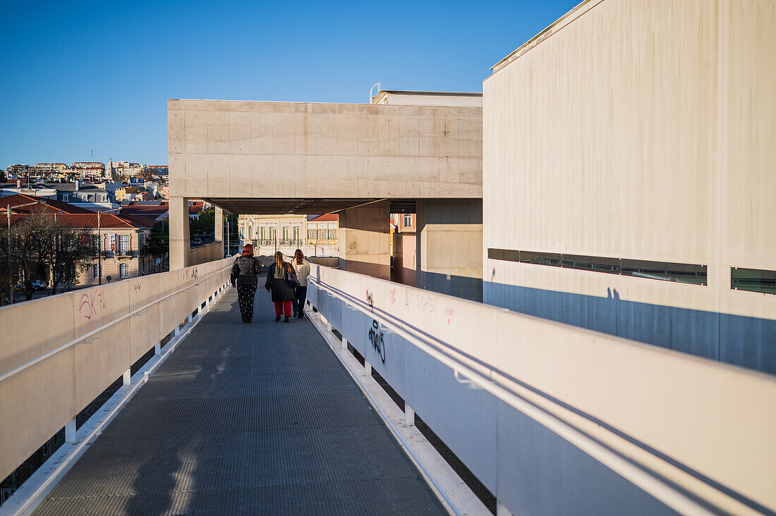 People crossing bridge in Belem, Lisbon, Portugal