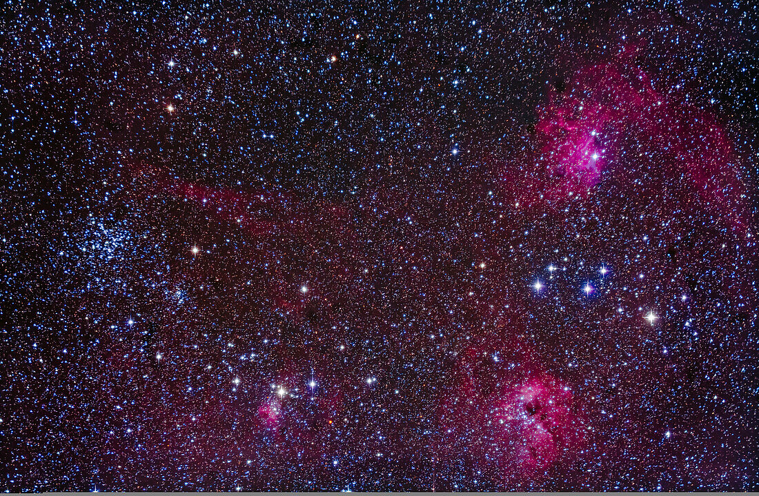 The Messier star cluster M38 at left, with the smaller NGC 1907 cluster below, amid a complex field of nebulosity in central Auriga, including from left to right: IC 417 (at bottom), IC 410 (lower right), and IC 405 (at upper right), aka the Flaming Star Nebula.