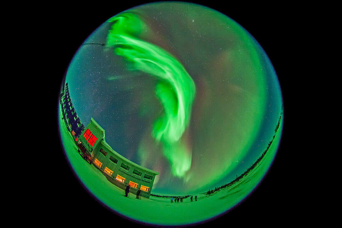 The aurora of February 3-4, 2014 seen from Churchill, Manitoba at the Churchill Northern Studies Centre, in an all-sky view with the 8mm fish-eye lens. This is a 20-second exposure at f/3.5 and ISO 3200 wth the Canon 5D MkII. This is looking north and east. Members of the aurora tour group are in the foreground, in front of the main CNSC building.