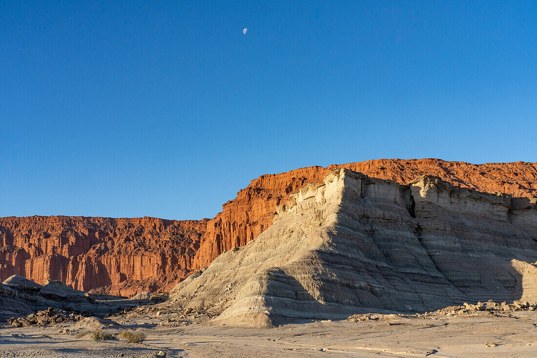The moon over eroded geologic formations in Ischigualasto Provincial Park in San Juan Province, Argentina.